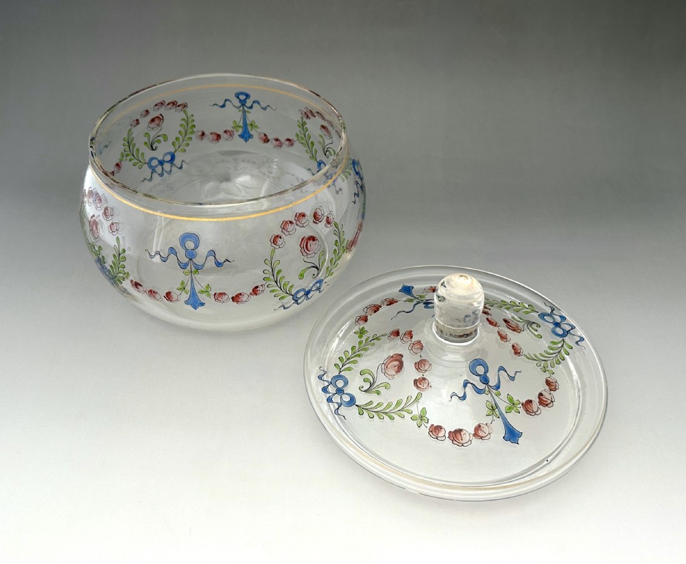 A clear glass lidded biscuit jar decorated with hand-painted enamelled pink roses, green foliage, and blue ribbons with a gilded rim band. View IV