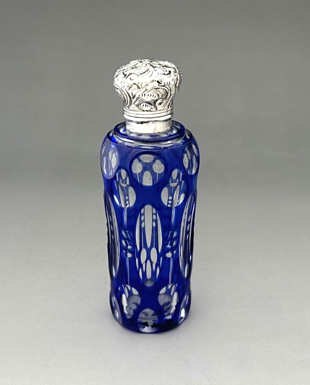 An attractive Victorian silver mounted cut through scent bottle