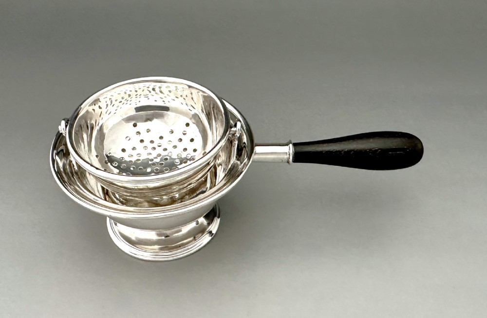 An excellent George V silver tea strainer & drip cup