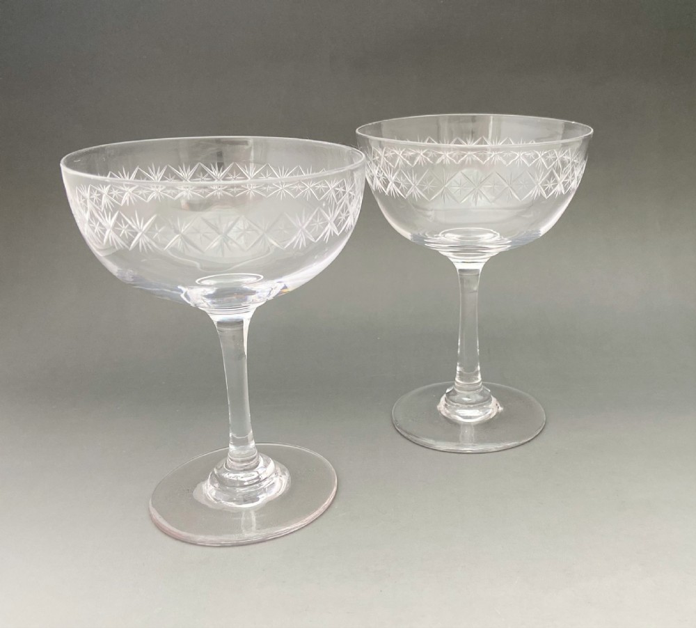 An elegant pair of star cut glass champagne bowls