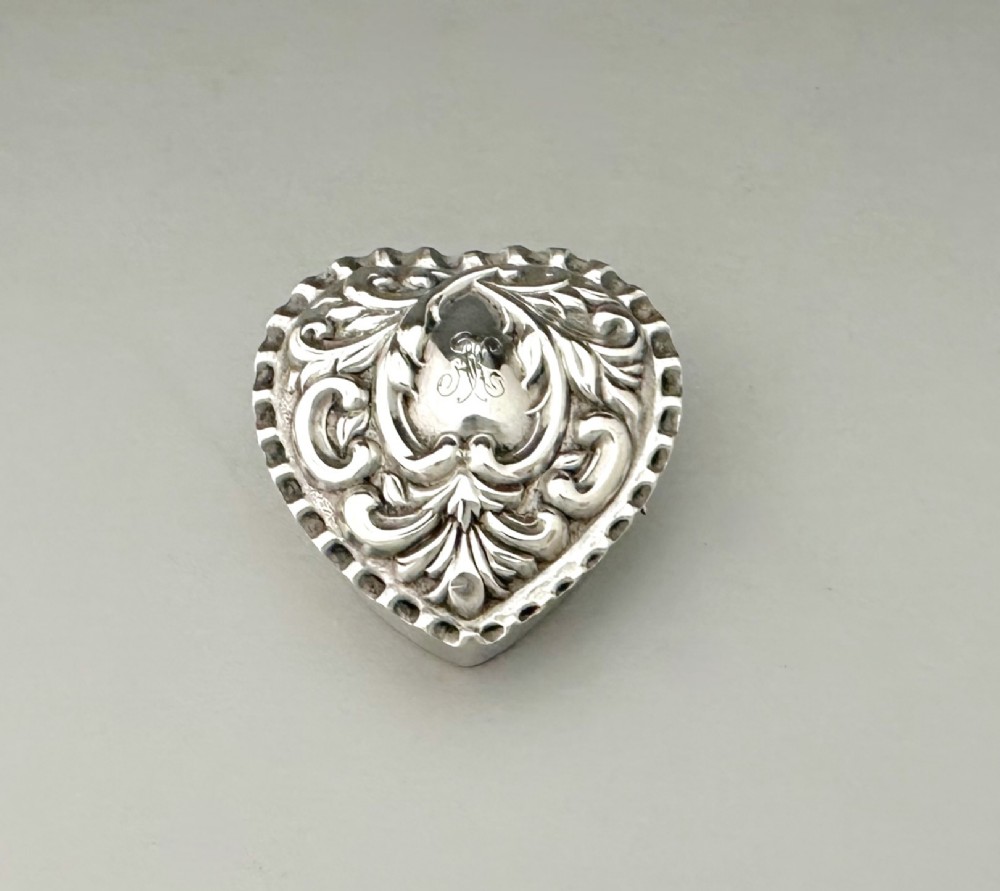 A delightful Victorian silver heart shaped pillbox pendant