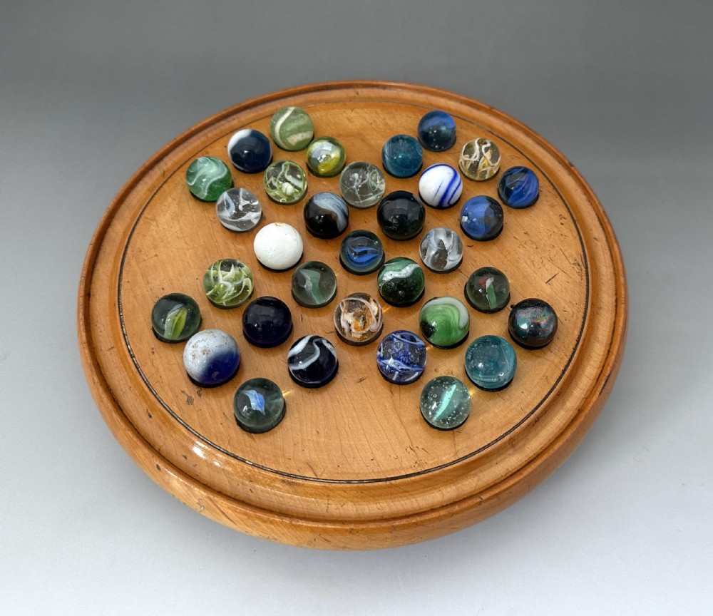 An attractive Victorian Solitaire board & glass marbles