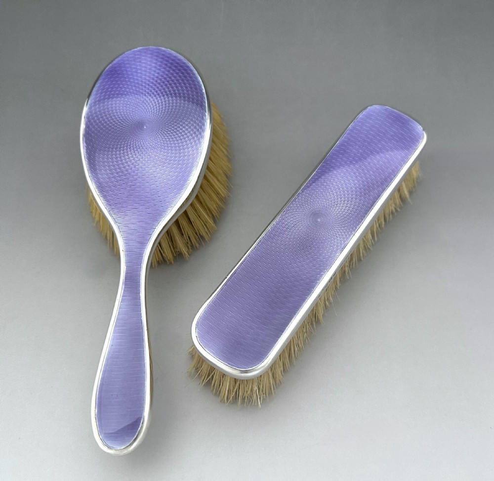 A lovely pair of George V silver & guilloche enamel brushes