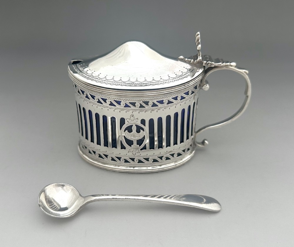 Victorian pierced sterling silver mustard pot with a domed hinged lid, scroll handle, and cobalt blue glass liner. View IV