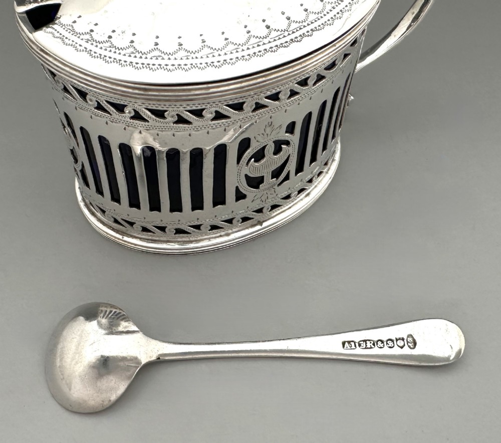 Victorian pierced sterling silver mustard pot with a domed hinged lid, scroll handle, and cobalt blue glass liner. View X