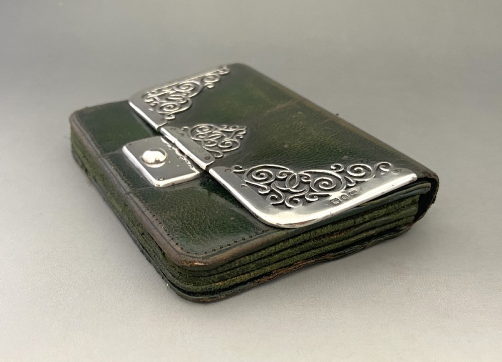 A dark green leather purse featuring intricate silver Art Nouveau corner mounts and a central silver clasp. View III
