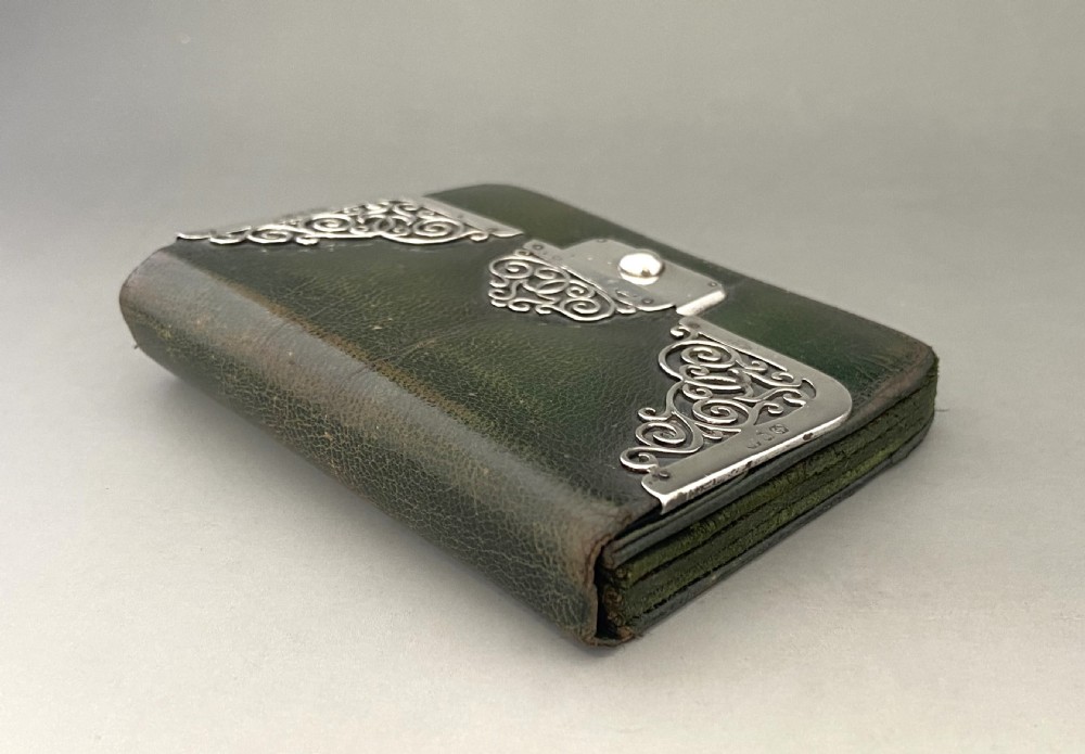 A dark green leather purse featuring intricate silver Art Nouveau corner mounts and a central silver clasp. View IV