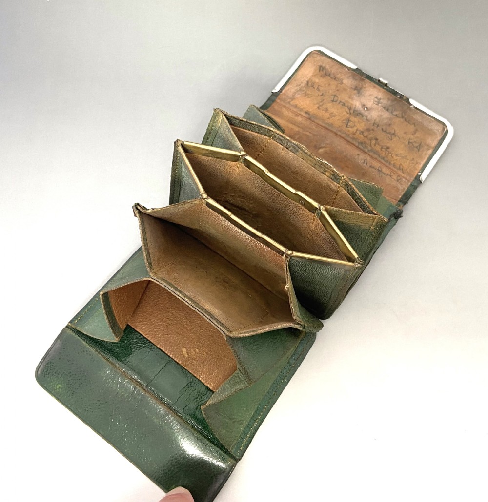 A dark green leather purse featuring intricate silver Art Nouveau corner mounts and a central silver clasp. View VII