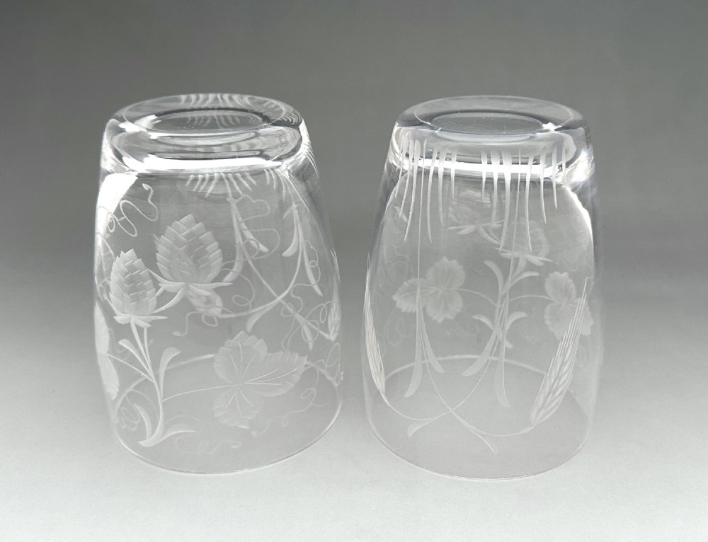 A pair of clear glass tumblers decorated with wheel-engraved botanical motifs depicting hops and barley. View VI