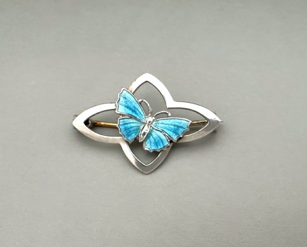 A charming silver & enamel butterfly brooch