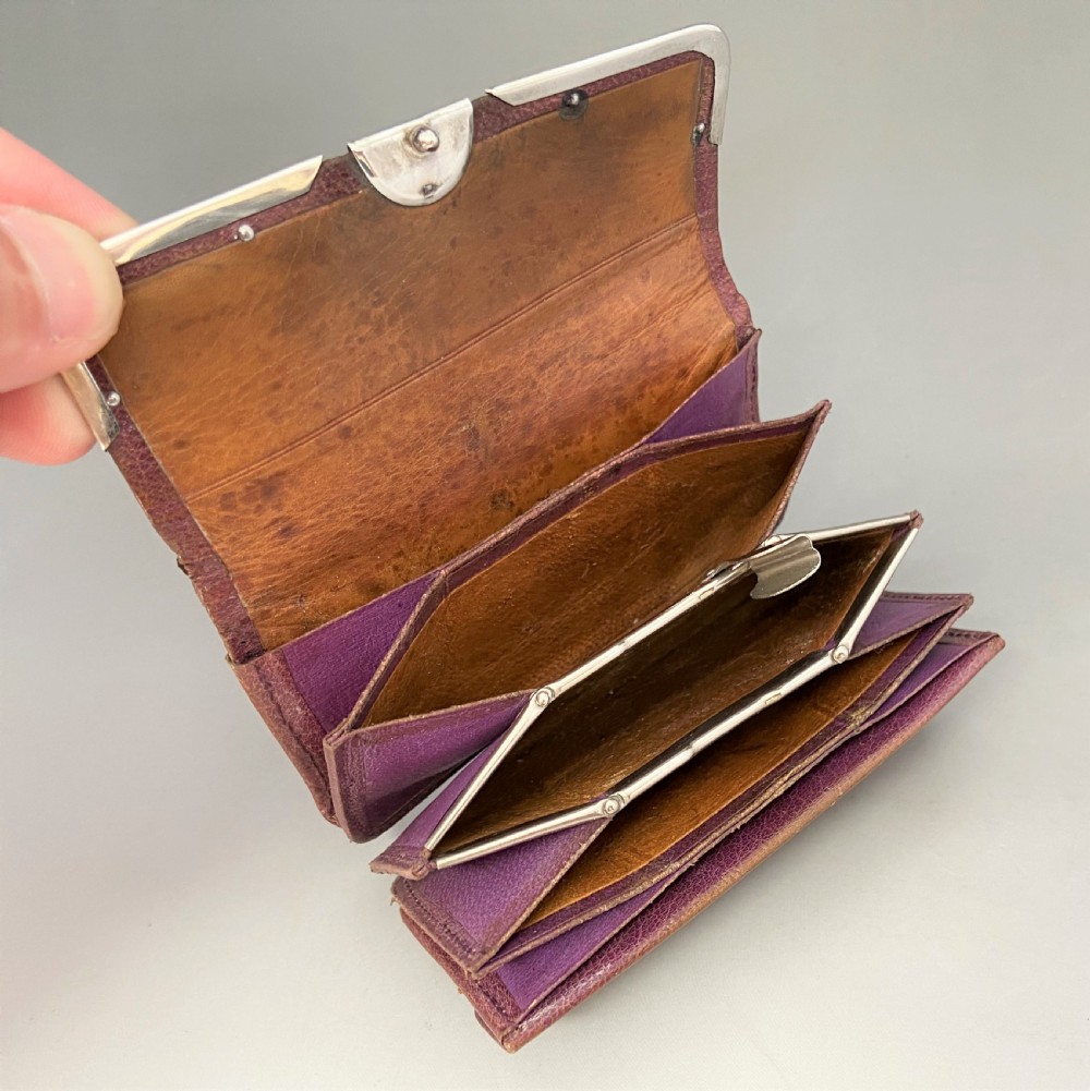 An Edwardian brown leather purse featuring hallmarked sterling silver corner mounts and a central silver clasp fastener. View VI