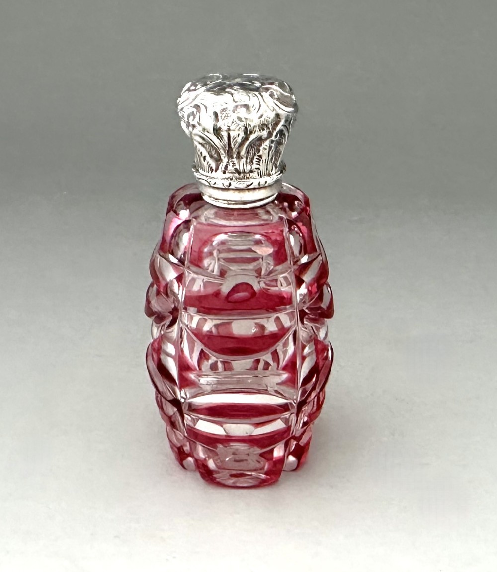 A gorgeous silver mounted cut through cranberry scent bottle