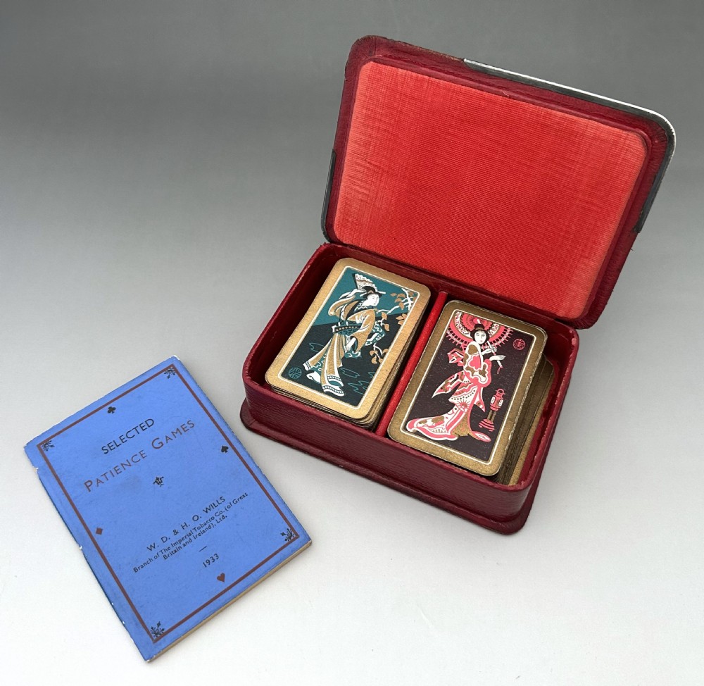 A rectangular red textured leather card box featuring silver corner mounts and silver script reading Patience across the top. View V