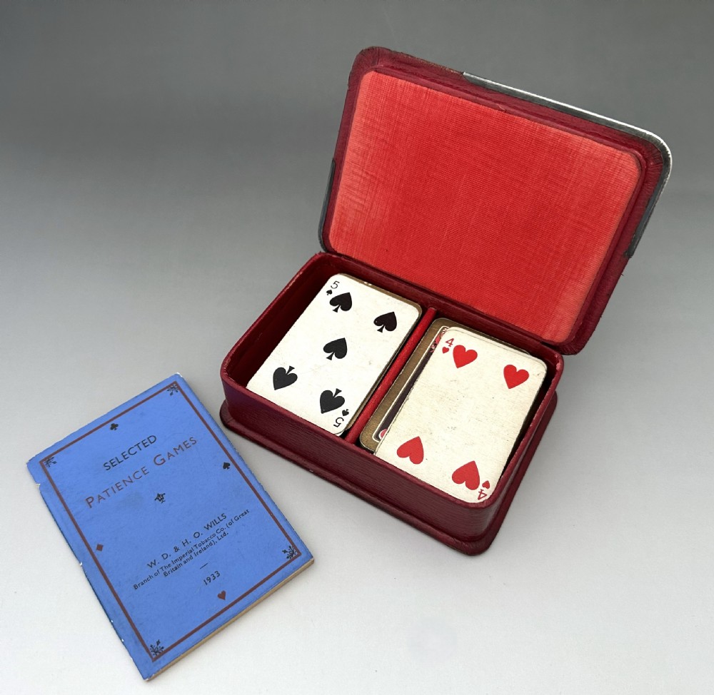 A rectangular red textured leather card box featuring silver corner mounts and silver script reading Patience across the top. View VIII