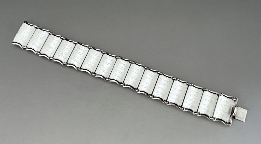 A Scandinavian sterling silver panel bracelet decorated with white guilloche enamel and dark contrasting borders. View II