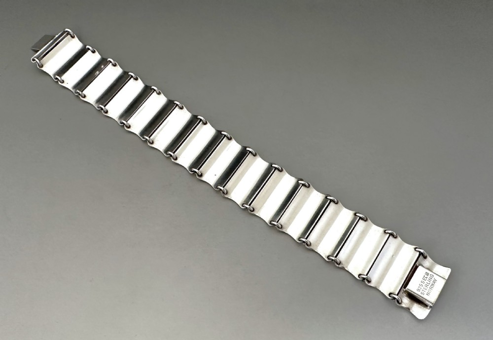 A Scandinavian sterling silver panel bracelet decorated with white guilloche enamel and dark contrasting borders. View VII