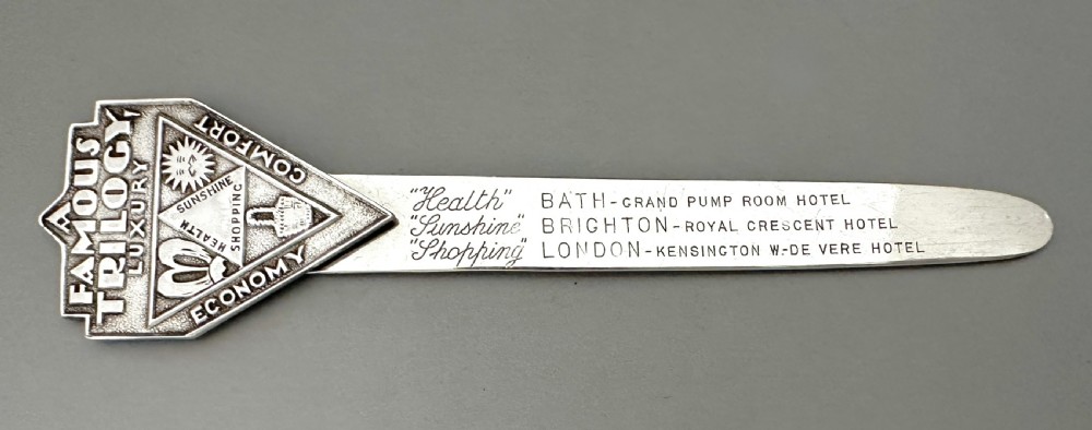 An Art Deco silver novelty advertising bookmark featuring an embossed crest and an engraved flat stem detailing historic English hotels. View III