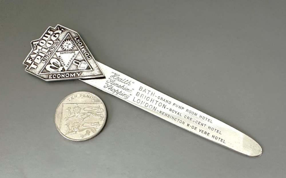 An Art Deco silver novelty advertising bookmark featuring an embossed crest and an engraved flat stem detailing historic English hotels. View VI