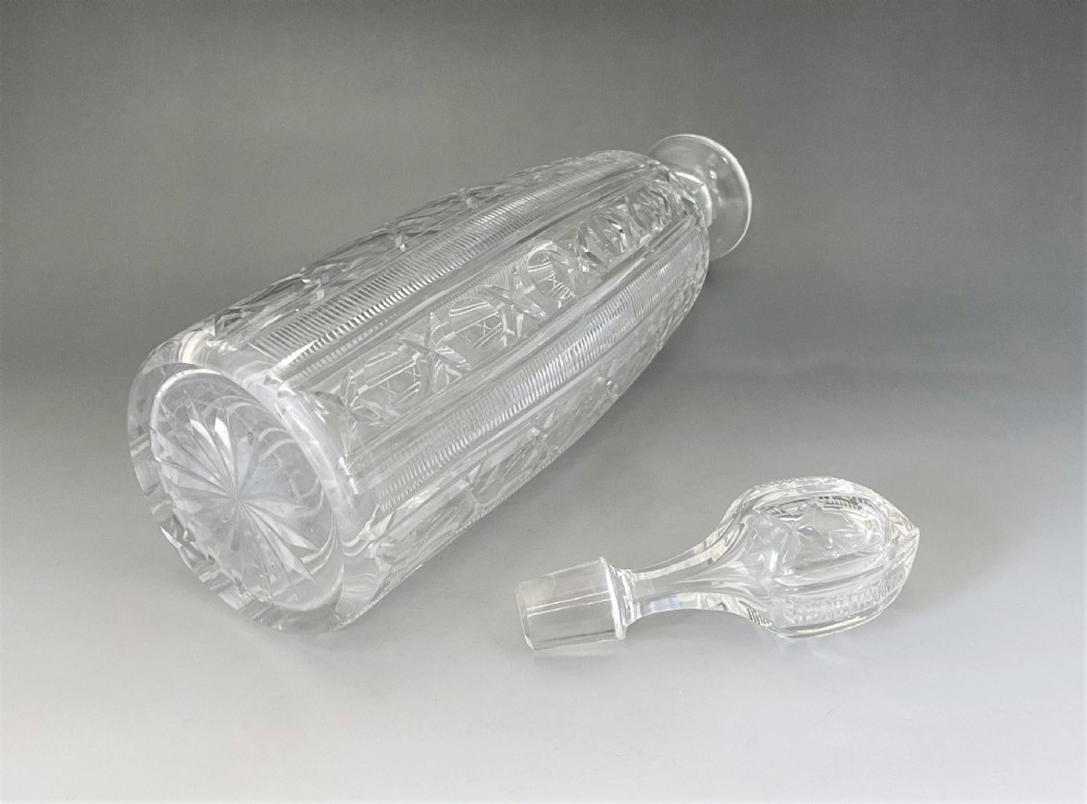 A tall clear Victorian cut glass decanter featuring geometric star and diamond pattern cuttings with a fitted faceted glass stopper. View III