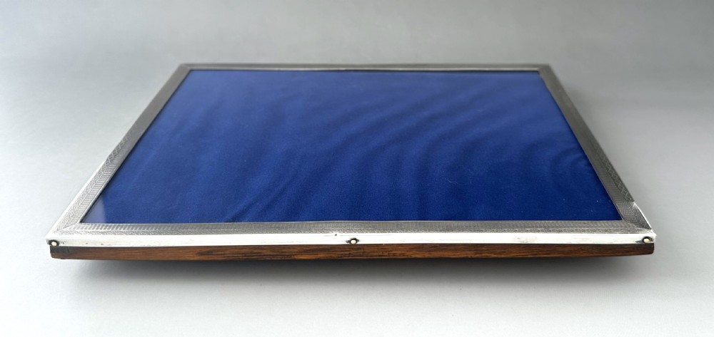 An Art Deco rectangular silver photo frame featuring engine-turned geometric borders and a standing back. View IV
