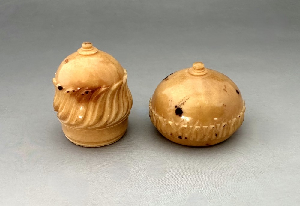 Carved cream and light brown Corozo nut thimble case shaped like an acorn with detailed fluted relief work. View VII