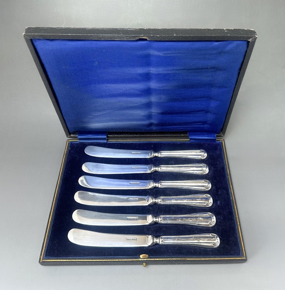 A useful set of 6 boxed silver handled butter knives