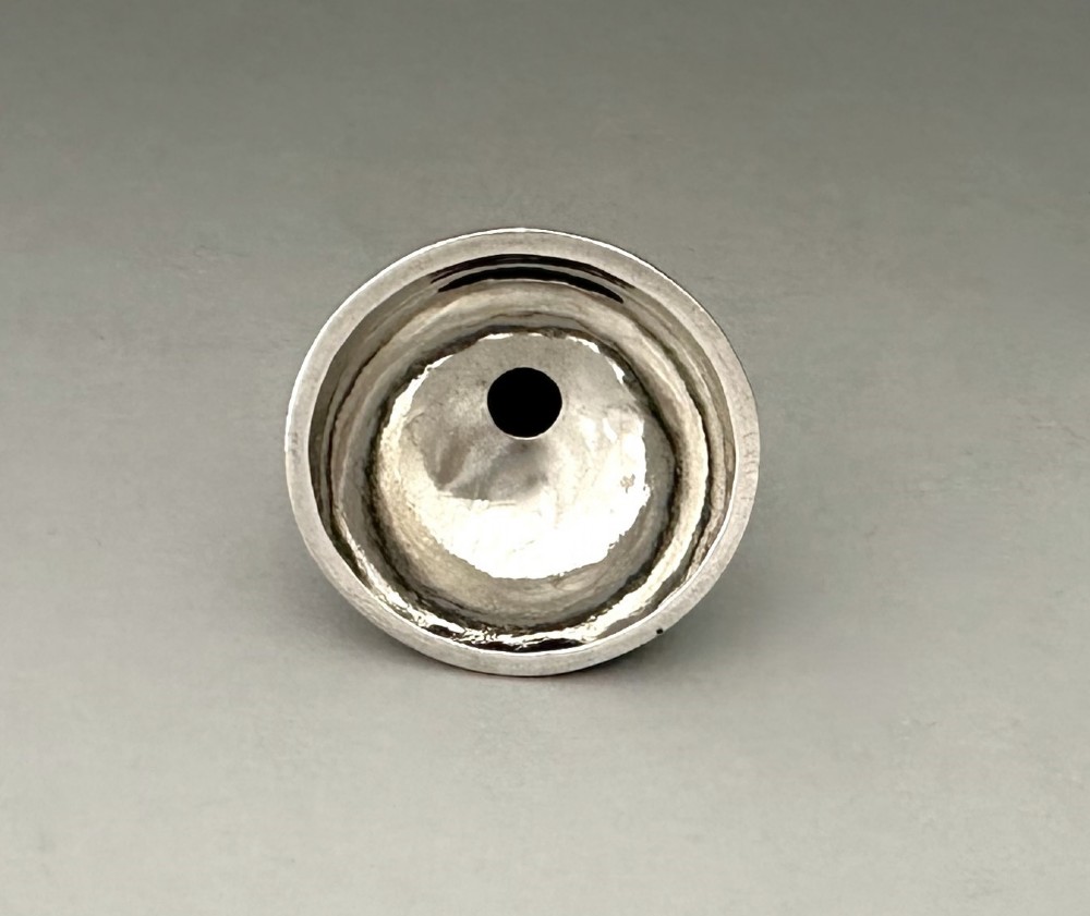 An Old Sheffield plate silver perfume funnel featuring a conical bowl and a narrow tapered spout resting upright. View III