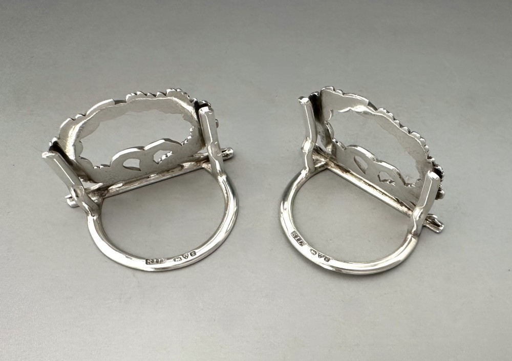 A pair of sterling silver menu card holders shaped as laurel and oak leaf wreaths tied with a ribbon bow on a flat base with rear support struts. View III