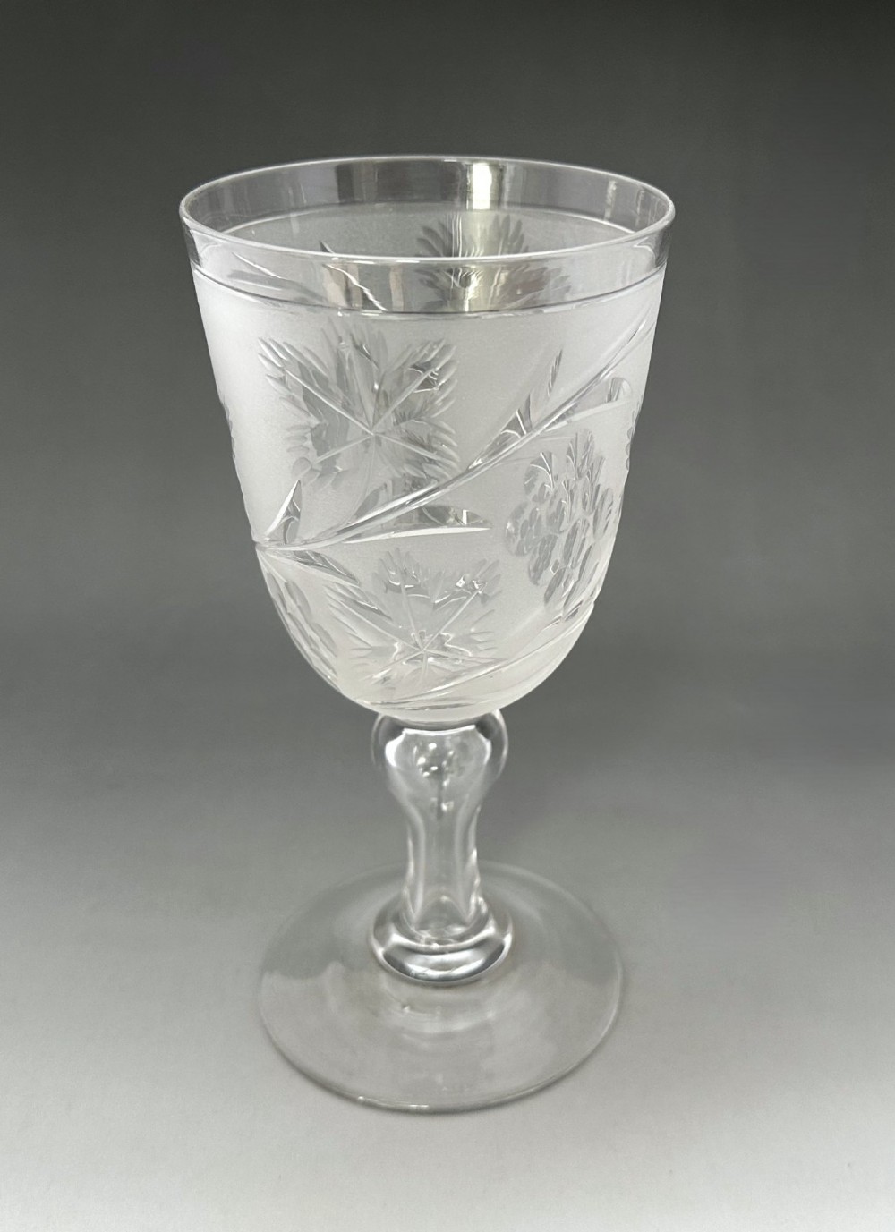 A set of six clear Victorian glass goblets, each featuring distinct hand-etched and cut geometric and floral patterns. View IX