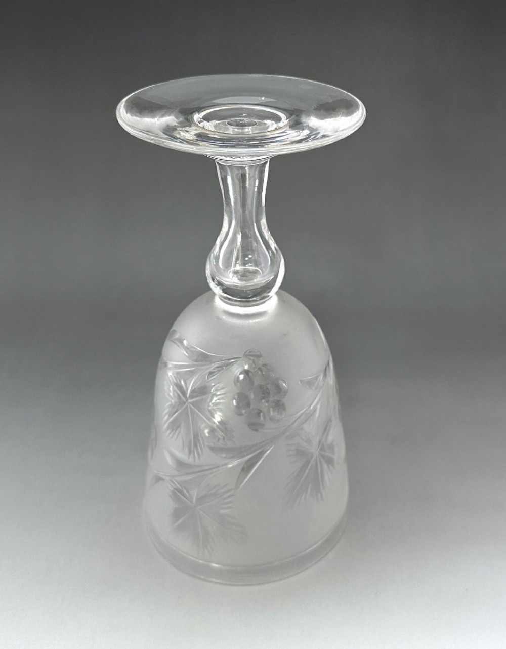 A set of six clear Victorian glass goblets, each featuring distinct hand-etched and cut geometric and floral patterns. View X