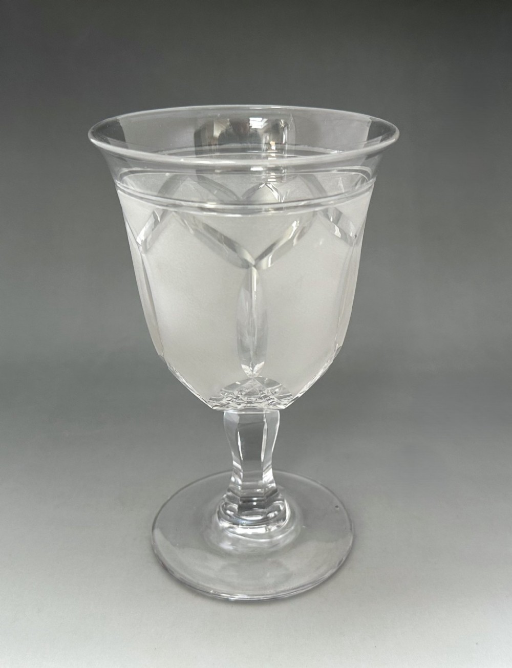 A set of six clear Victorian glass goblets, each featuring distinct hand-etched and cut geometric and floral patterns. View XI