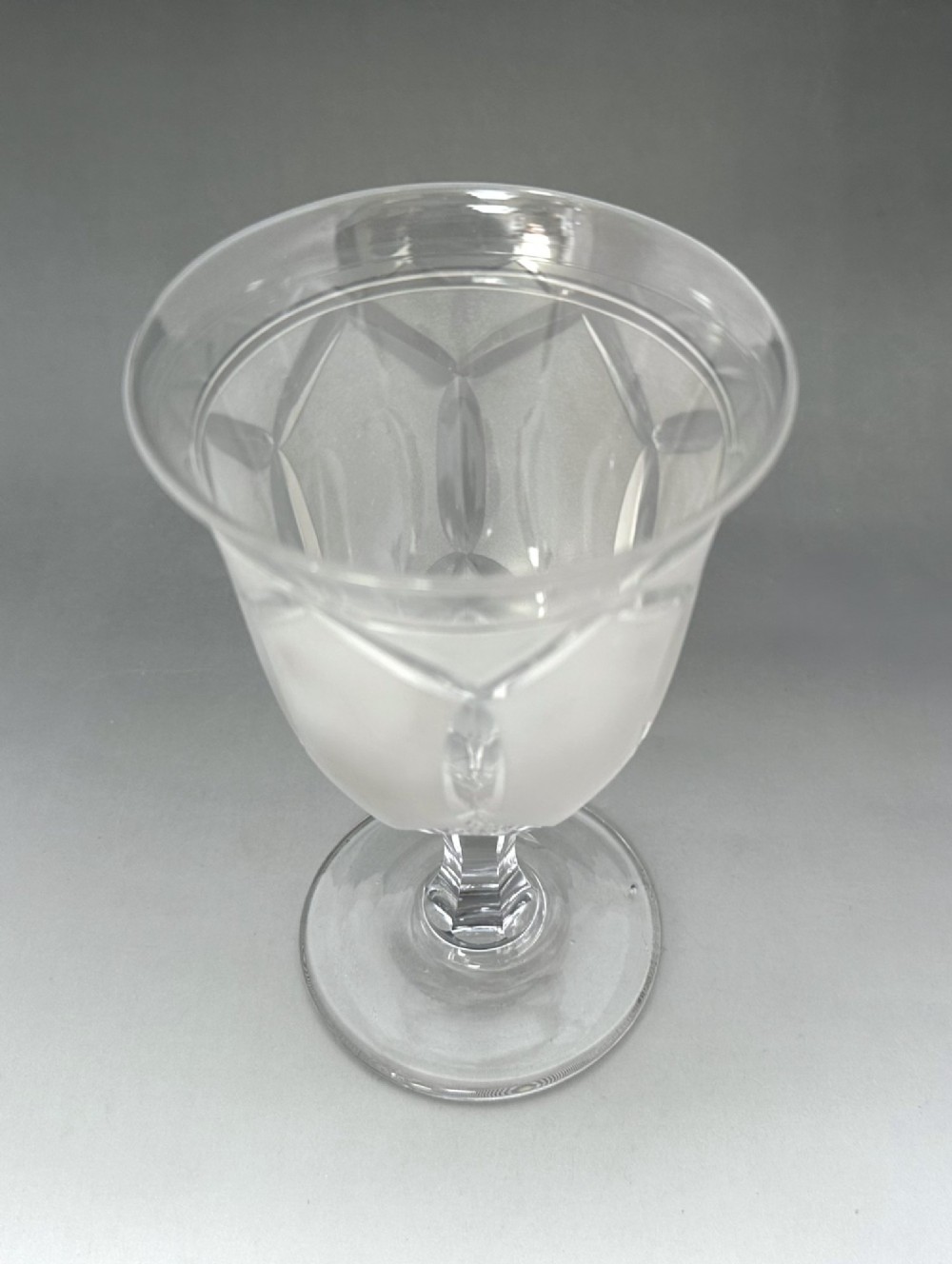 A set of six clear Victorian glass goblets, each featuring distinct hand-etched and cut geometric and floral patterns. View XII