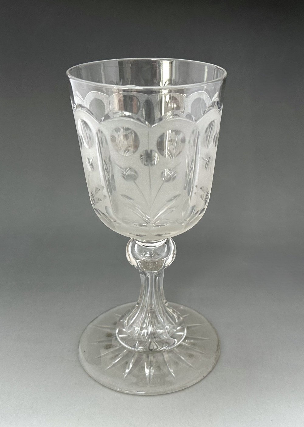 A set of six clear Victorian glass goblets, each featuring distinct hand-etched and cut geometric and floral patterns. View XIV