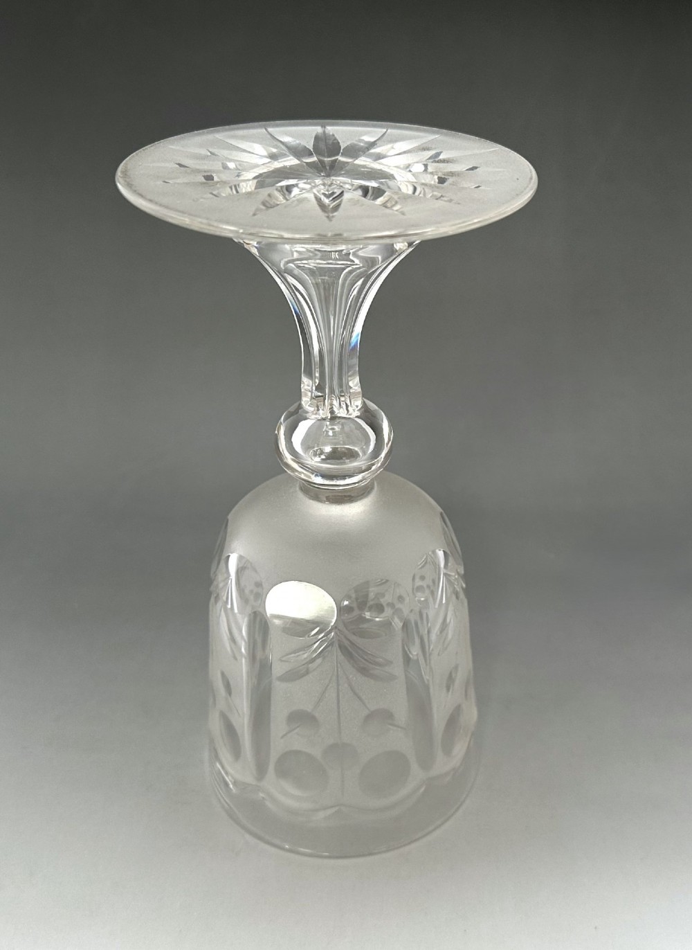A set of six clear Victorian glass goblets, each featuring distinct hand-etched and cut geometric and floral patterns. View XV