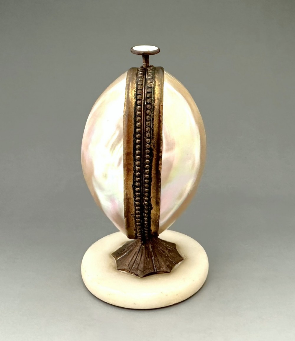 An open French Palais Royal mother-of-pearl egg-shaped etui featuring gilt bronze trim, a green velvet central cushion, and a round alabaster base. View II