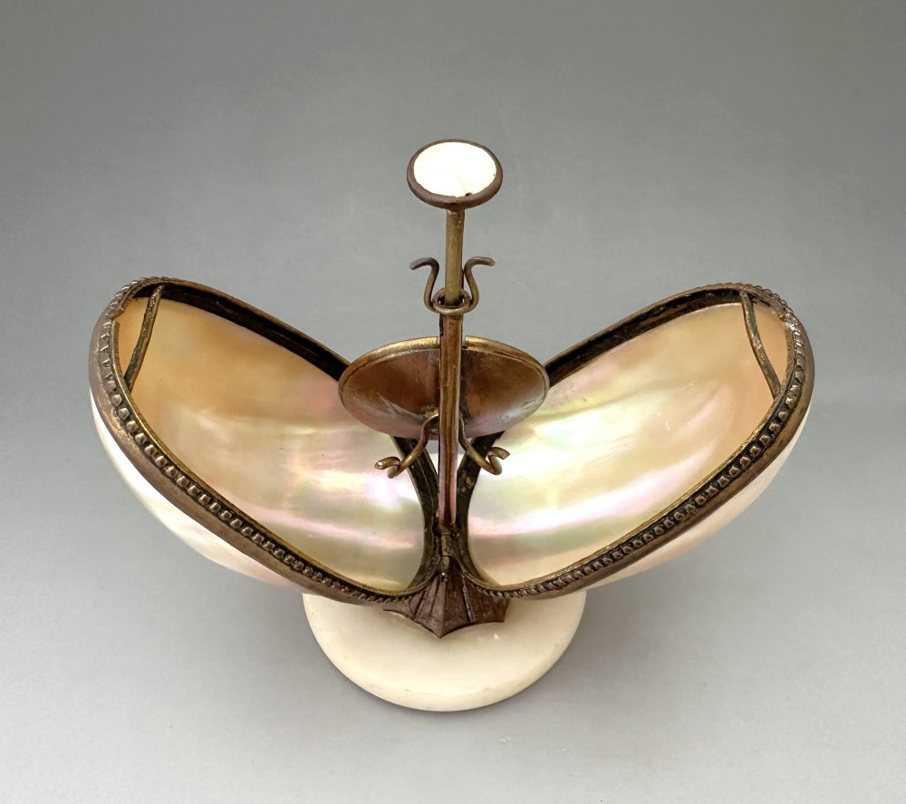 An open French Palais Royal mother-of-pearl egg-shaped etui featuring gilt bronze trim, a green velvet central cushion, and a round alabaster base. View V