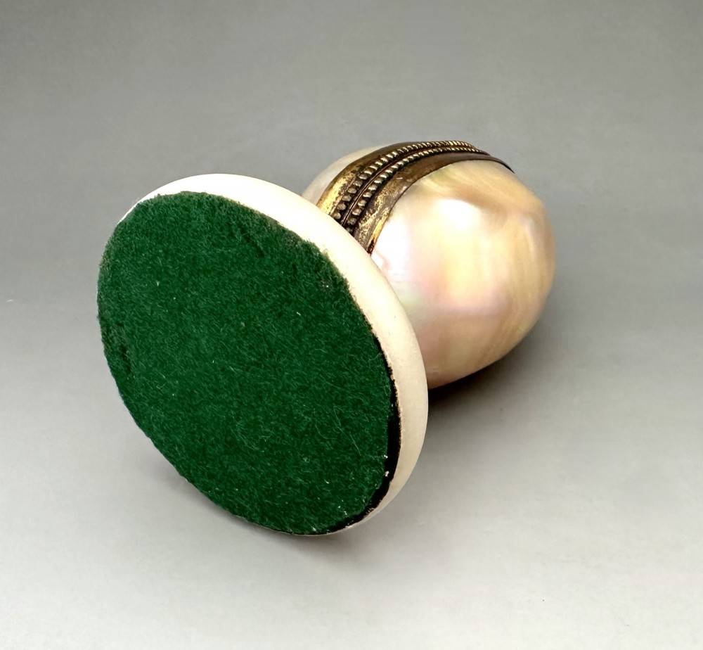 An open French Palais Royal mother-of-pearl egg-shaped etui featuring gilt bronze trim, a green velvet central cushion, and a round alabaster base. View VII