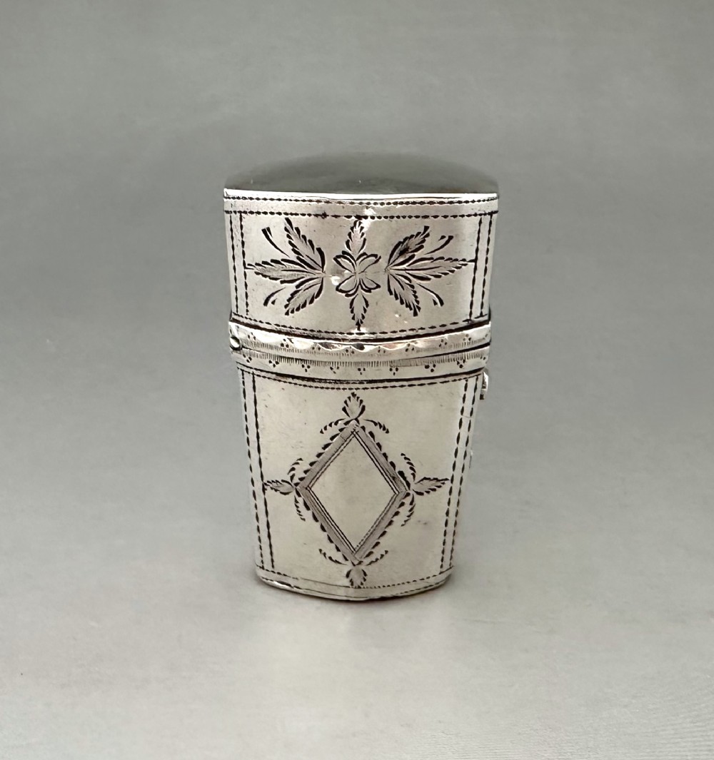 An antique Georgian sterling silver scent bottle case decorated with hand-engraved leaf and diamond motifs.