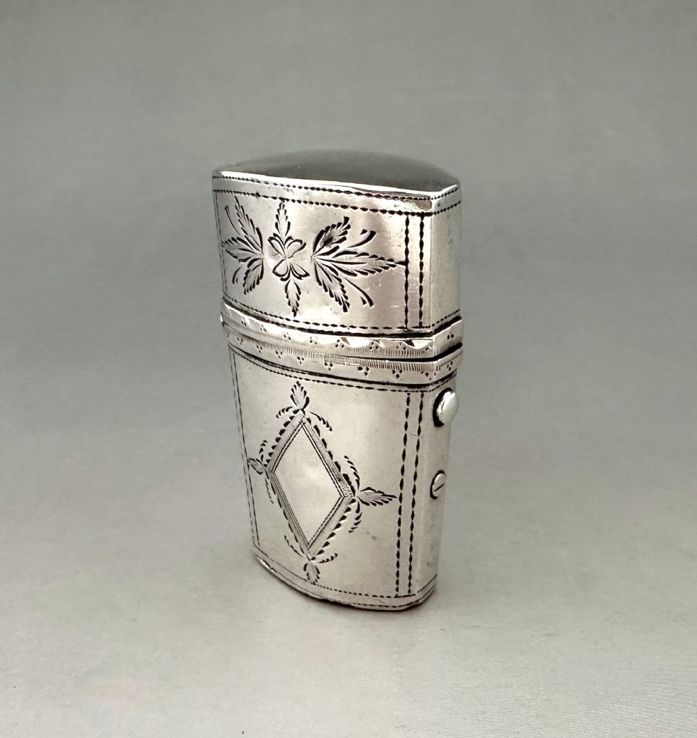 An antique Georgian sterling silver scent bottle case decorated with hand-engraved leaf and diamond motifs. View II