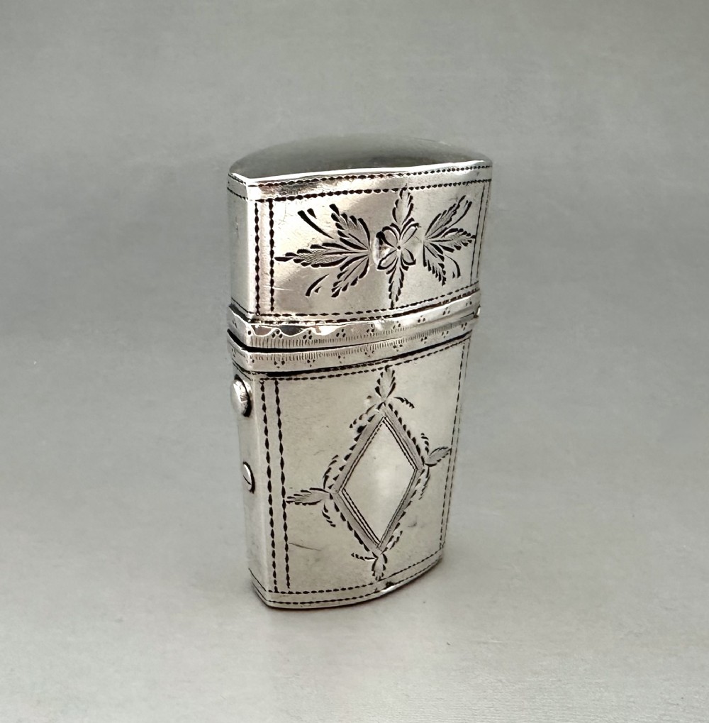 An antique Georgian sterling silver scent bottle case decorated with hand-engraved leaf and diamond motifs. View III
