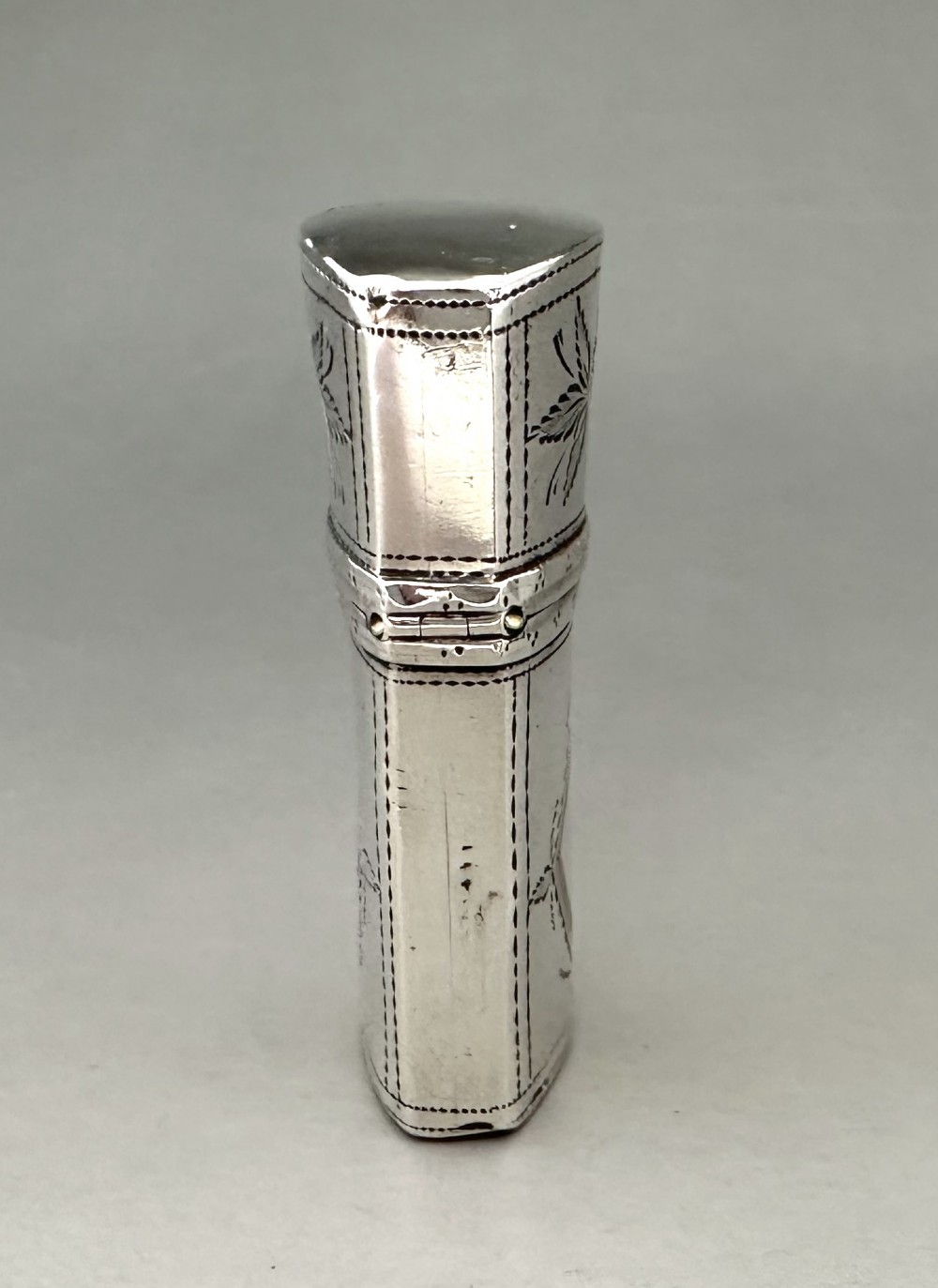 An antique Georgian sterling silver scent bottle case decorated with hand-engraved leaf and diamond motifs. View IV