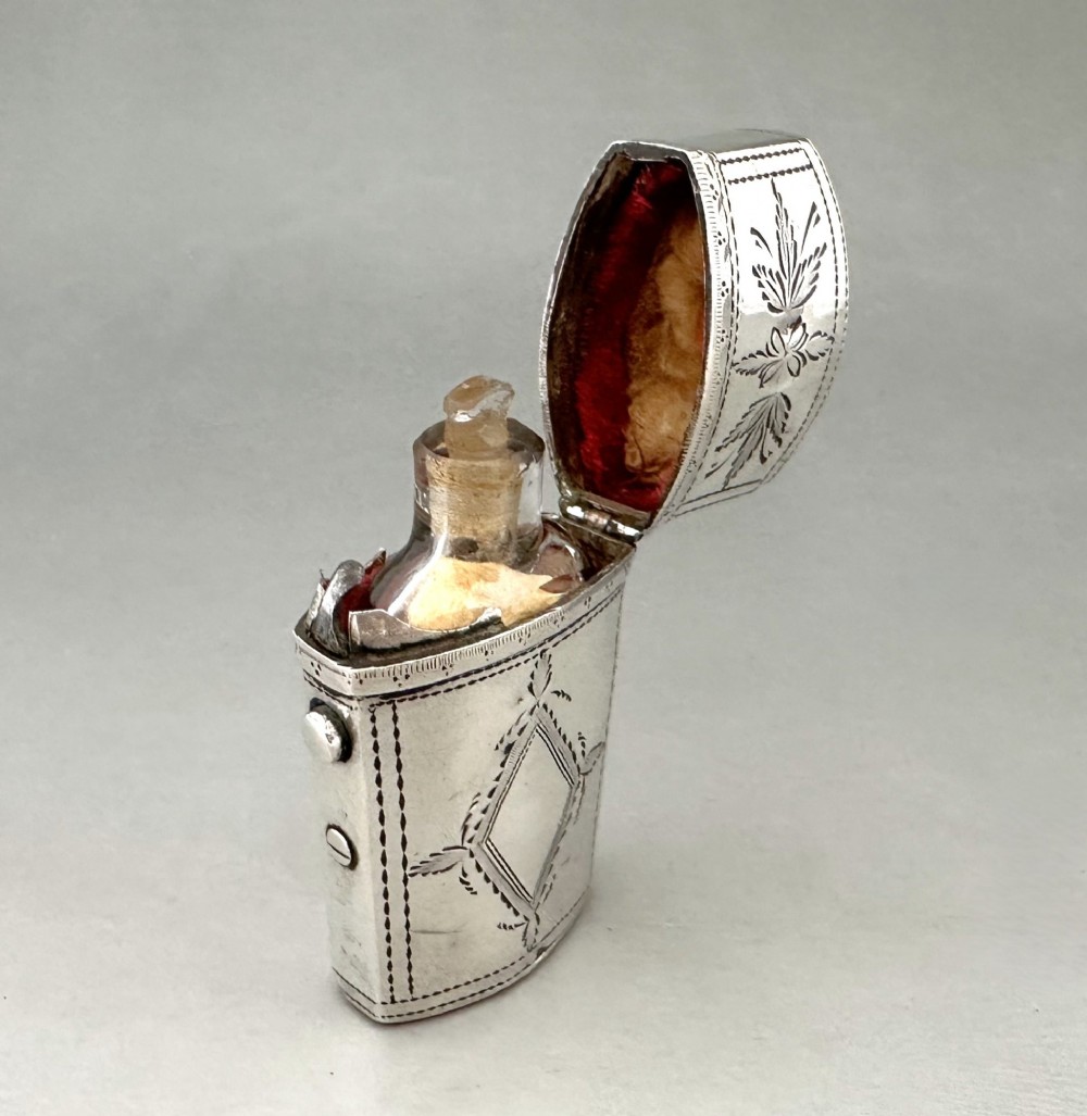 An antique Georgian sterling silver scent bottle case decorated with hand-engraved leaf and diamond motifs. View VI