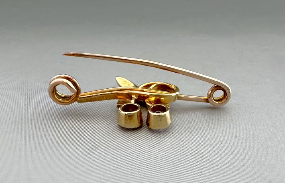 Victorian 9ct gold bar brooch featuring a central cherry motif with seed pearl leaves and two faceted pink gemstones. View VI