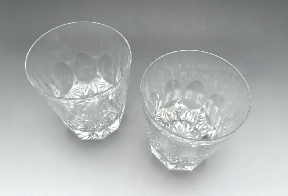 A pair of clear cut glass whisky tumblers featuring arched facet cuts and starburst bases. View II