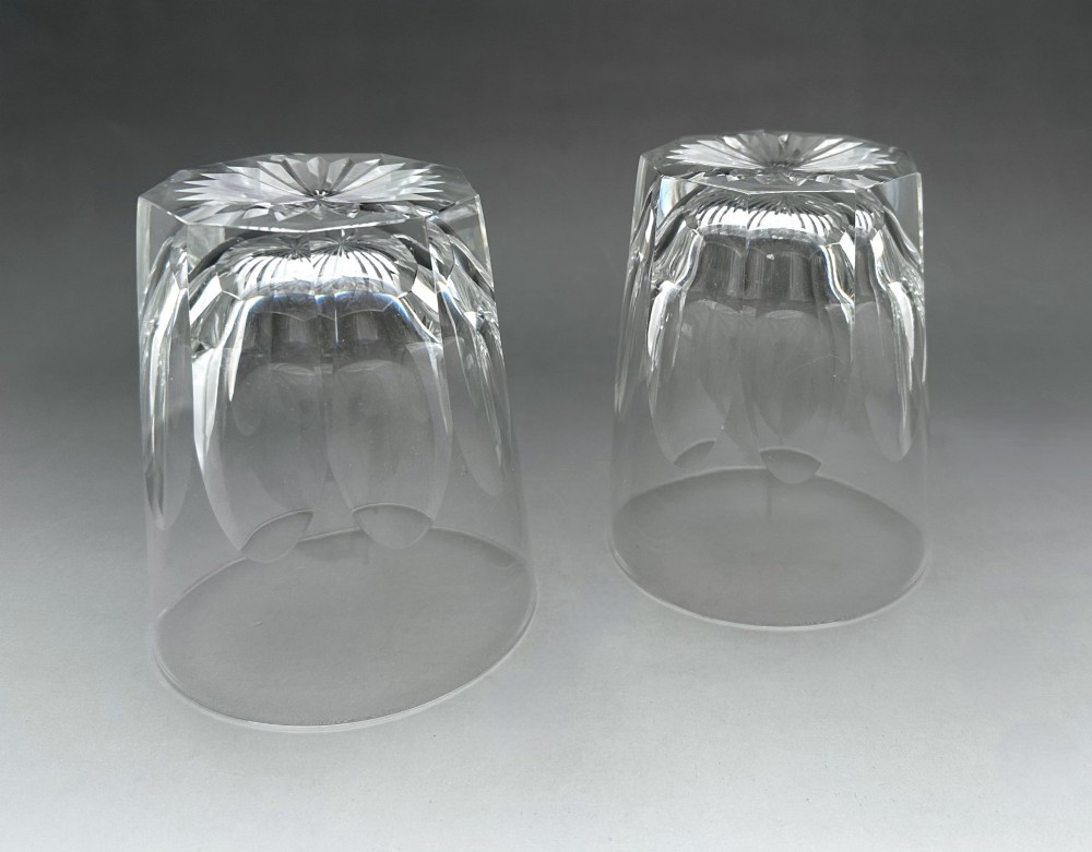 A pair of clear cut glass whisky tumblers featuring arched facet cuts and starburst bases. View III