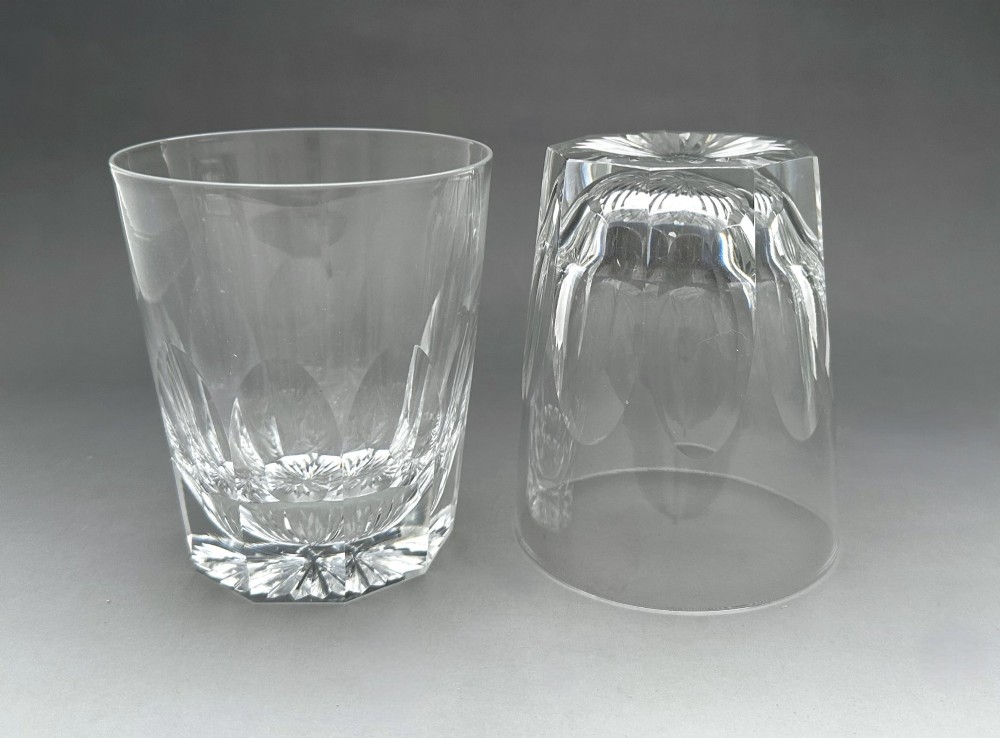 A pair of clear cut glass whisky tumblers featuring arched facet cuts and starburst bases. View V