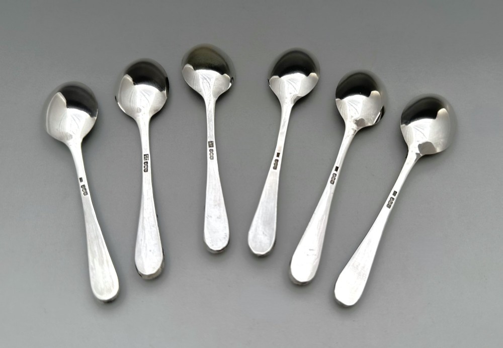 A boxed set of six Scottish sterling silver demi-tasse spoons set with varied semi-precious cabochon stones in a blue fitted case. View VI