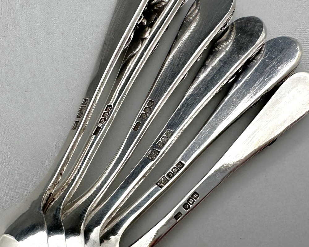 A boxed set of six Scottish sterling silver demi-tasse spoons set with varied semi-precious cabochon stones in a blue fitted case. View VIII