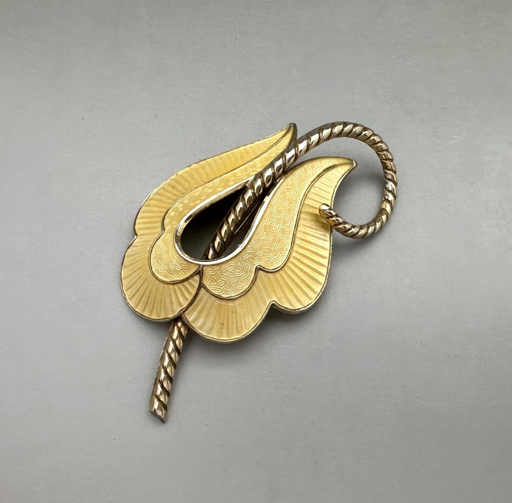 A leaf-shaped Norwegian silver gilt brooch featuring layered yellow guilloche enamel and twisted silver accents. View II
