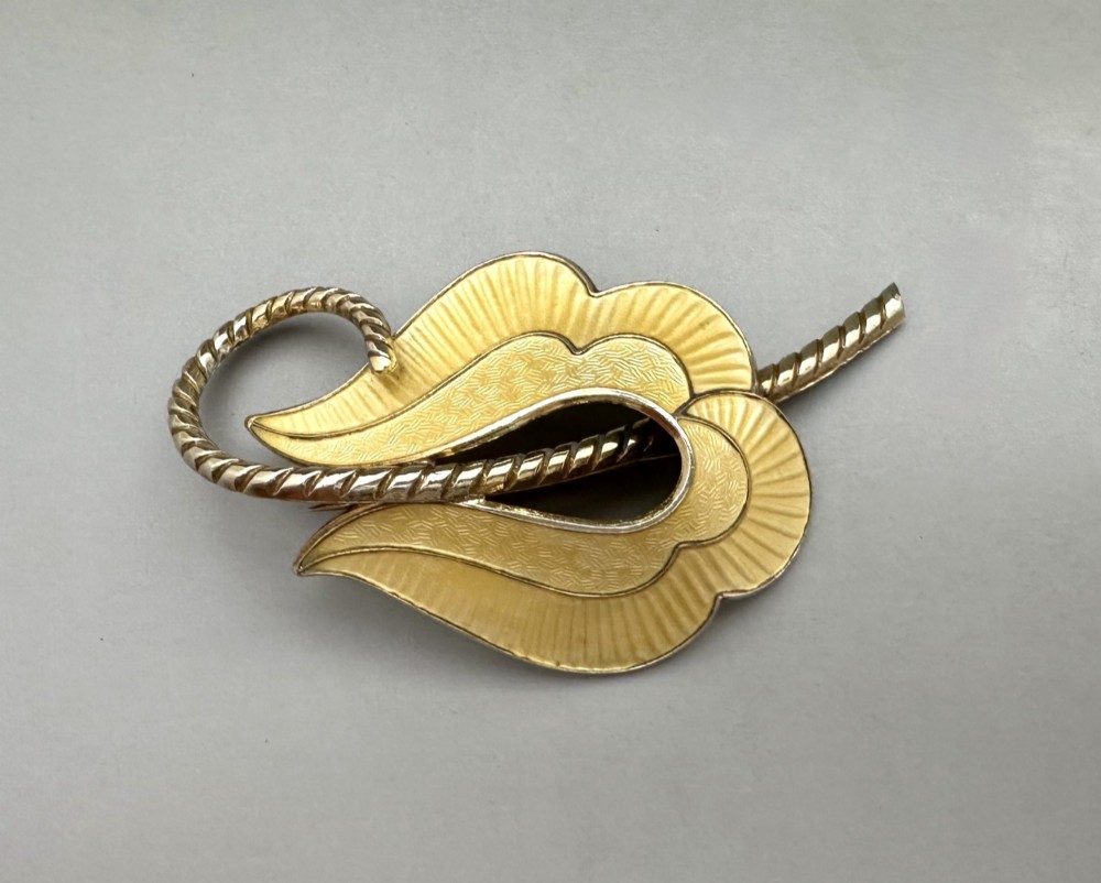A leaf-shaped Norwegian silver gilt brooch featuring layered yellow guilloche enamel and twisted silver accents. View III
